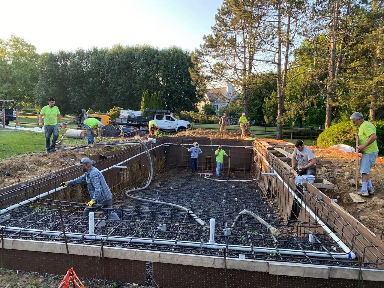 Pool gunite shell with rebar and plumbing during construction with Premier crew