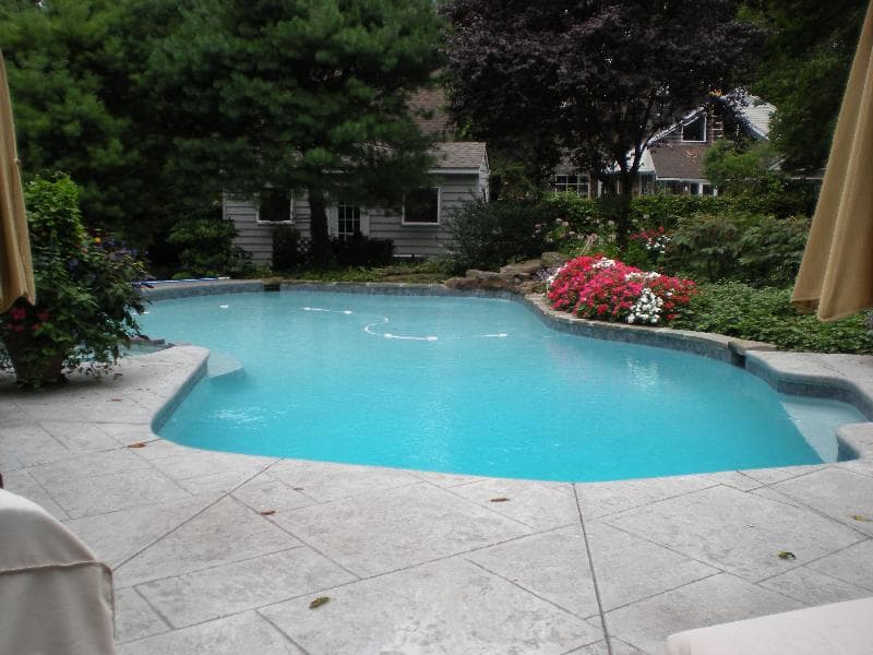 Neglected pool with green algae water before renovation — Premier Pool Renovations