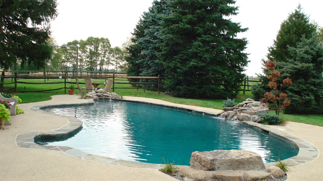 Detail of irregular flagstone pool coping transitioning to concrete deck
