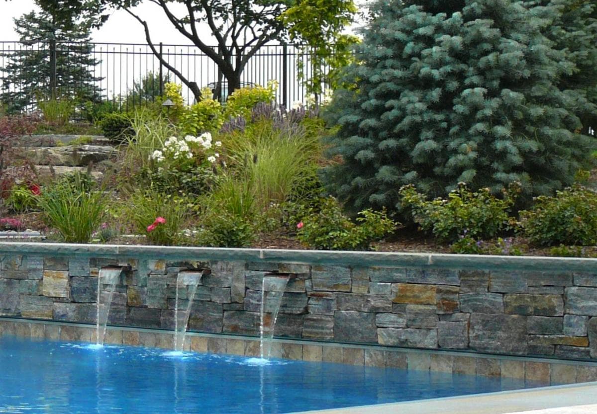 Stacked stone wall with twin sheer descent waterfalls — Premier Pool Renovations