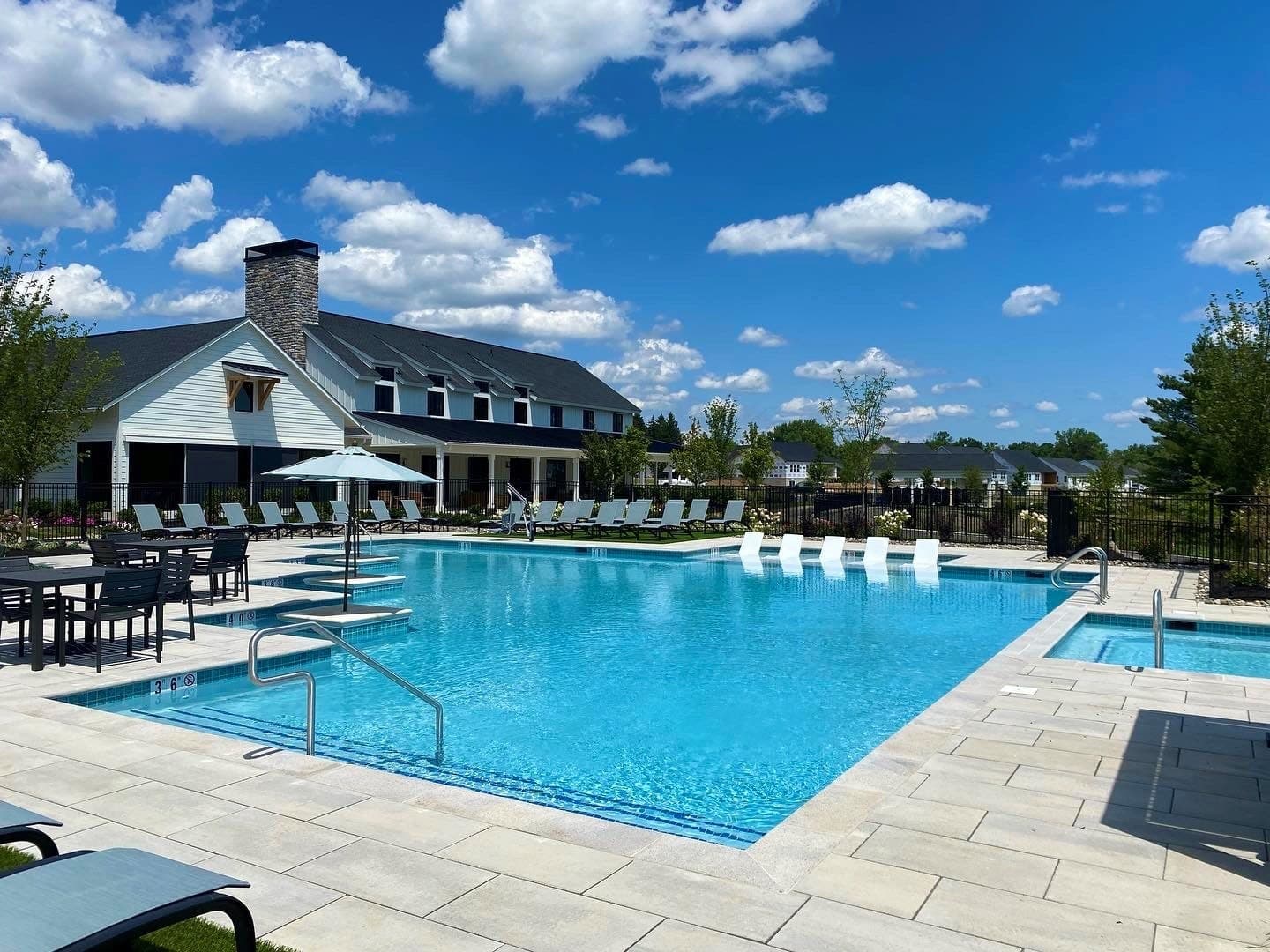 Finished community pool resurfacing with paver deck and clubhouse — Premier Pool Renovations