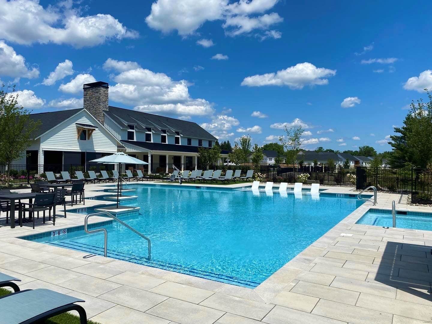 Finished community pool resurfacing with paver deck and clubhouse — Premier Pool Renovations