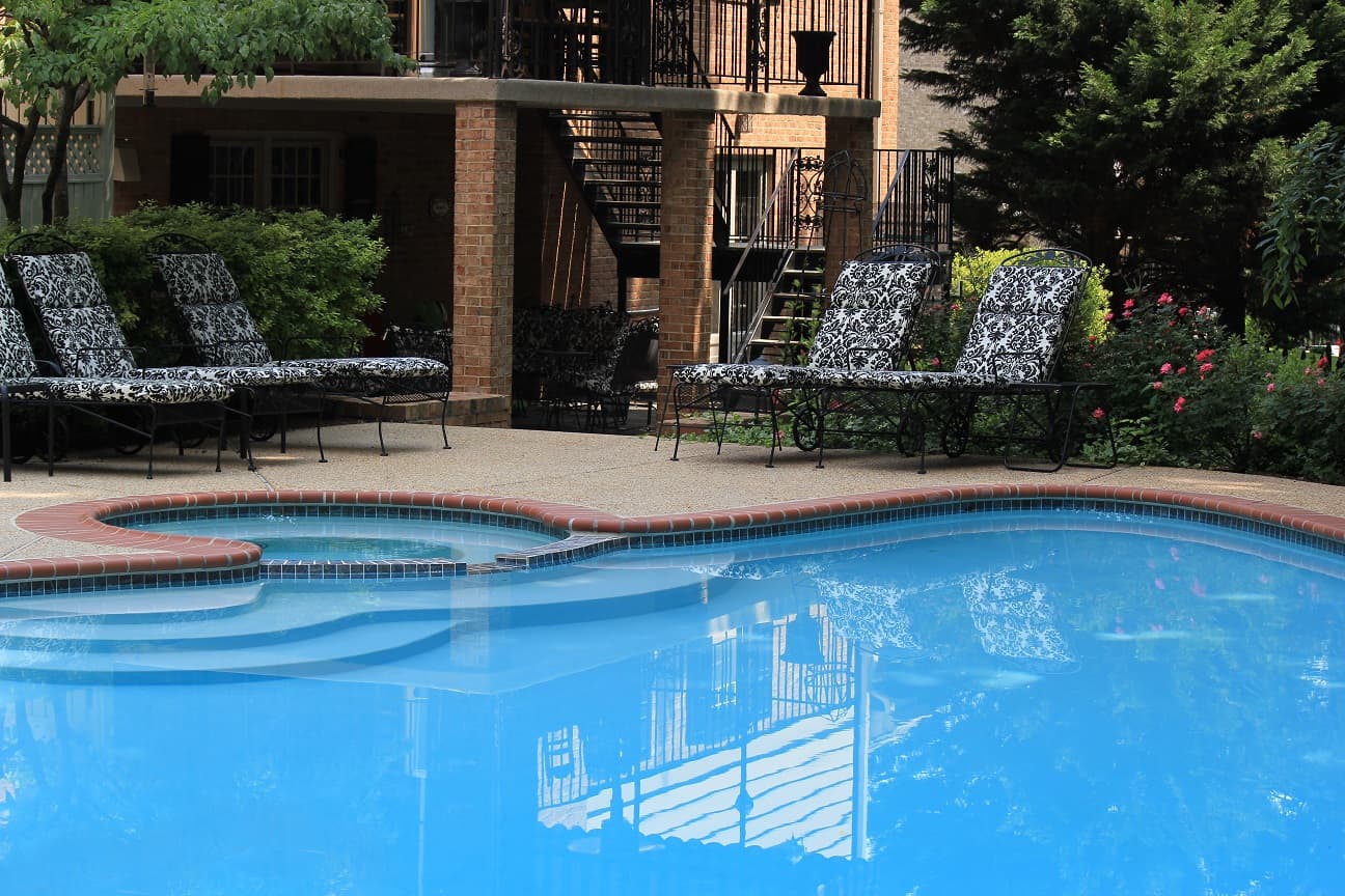 Pool corner with Plantation Red brick coping and aggregate deck — Premier Pool Renovations