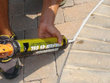 Sealant work on pool coping joint to prevent water intrusion into the bond beam — Premier Pool Renovations